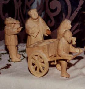 Mann mit Karren und weitere Figuren